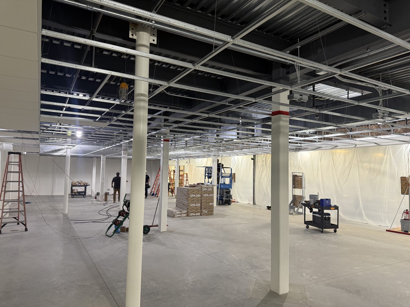Suspended ceiling grid with recessed fixtures set during an interior fit-out