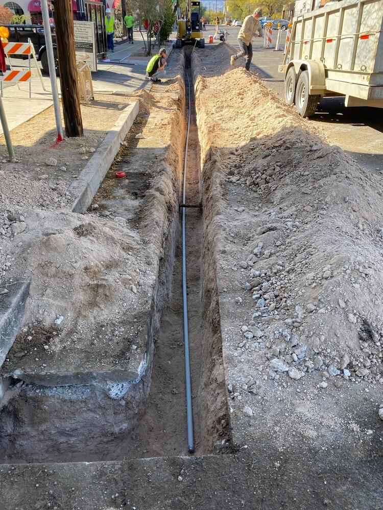 Conduit laid and racked in an open trench before backfill